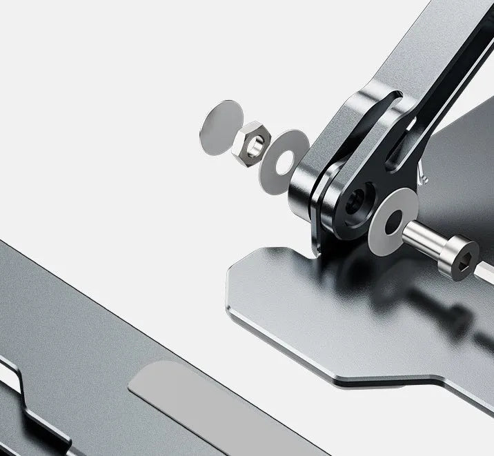 Grey aluminium laptop stand folded flat next to an open laptop, showing its adjustable angle and hollow design.