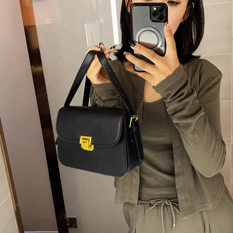 Soft black PU leather women's square cross-body bag with textured finish shown on model.
