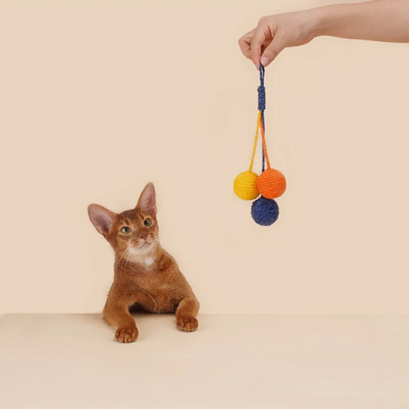 Four-piece cat toy set featuring a teaser stick and a catnip ball on a blue background