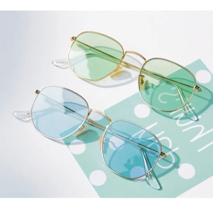 Retro street sunglasses with gold metal frame and transparent red resin lenses