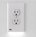 White plug-in socket night light with LED bulbs installed in a wall outlet.