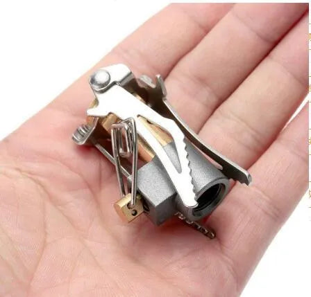 Portable folding mini camping stove made of stainless steel, copper, and aluminium with carry pouch