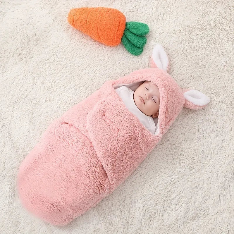 A baby wearing a soft grey fleece sleeping bag with hook-and-loop shoulder straps.