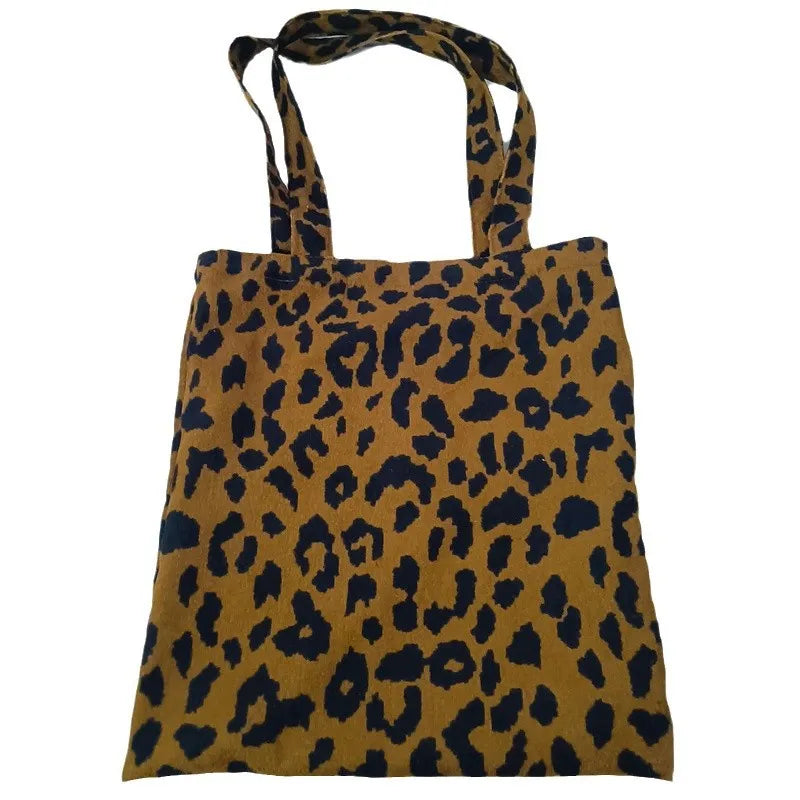 Corduroy leopard print shoulder bag in vertical square shape with open pocket, phone pocket, and document pocket.