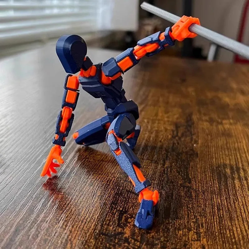 Multi-jointed 3D printed robot action model with movable limbs on a desk.