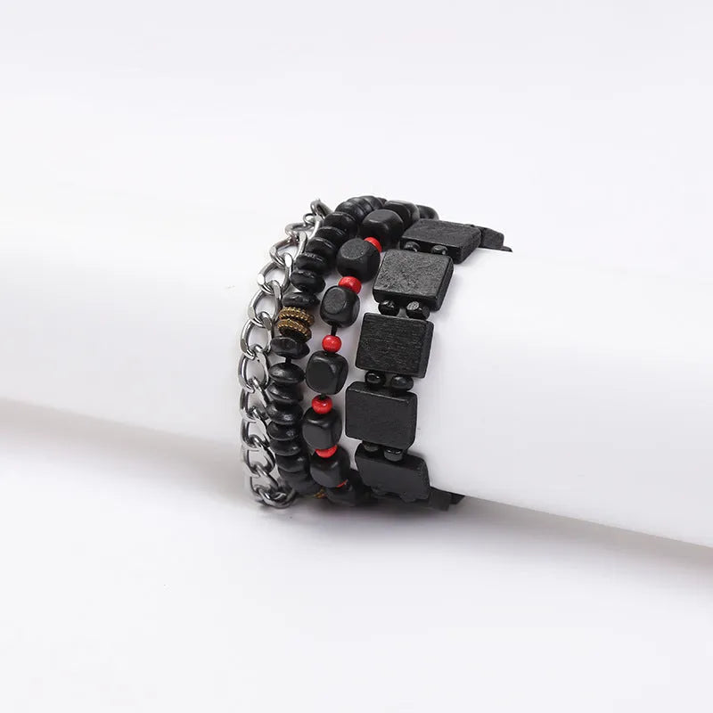 Set of four handmade retro woven alloy bracelets in different colours on a neutral background