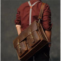 Genuine cowhide leather crossbody computer bag in solid colour with visible sewing lines