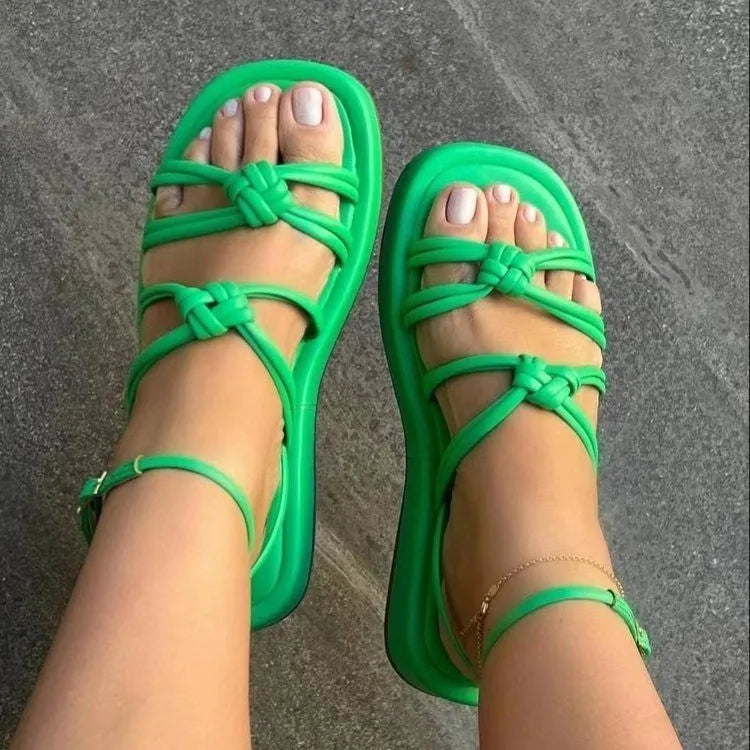Women's woven beach sandals with PU upper and ankle buckle in five colours including green and rose red