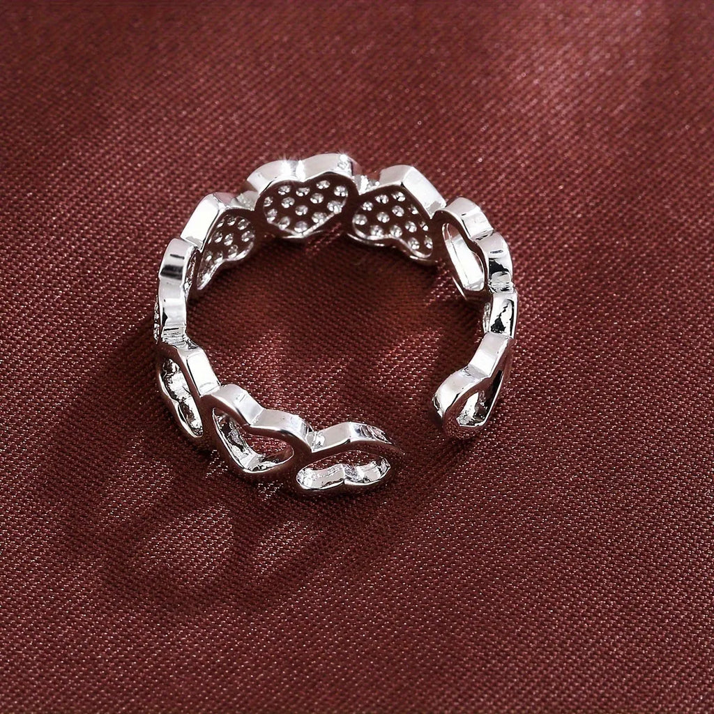 Adjustable copper fashion ring with a heart design, shown in gold and silver colour options.