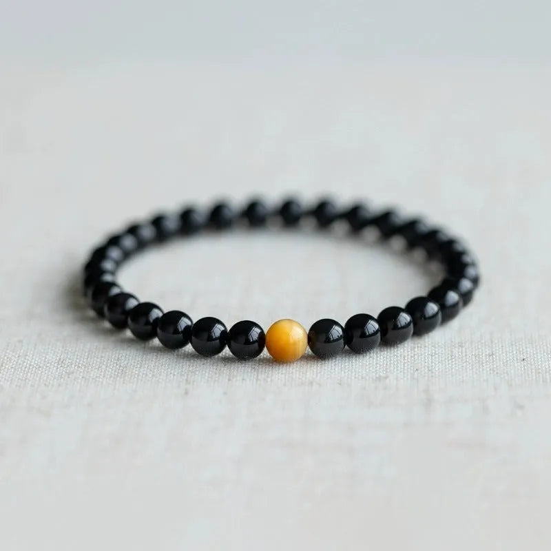 Black geometric obsidian bead bracelet shown in three size options: 6mm, 8mm, and 10mm beads.