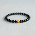 Black geometric obsidian bead bracelet shown in three size options: 6mm, 8mm, and 10mm beads.