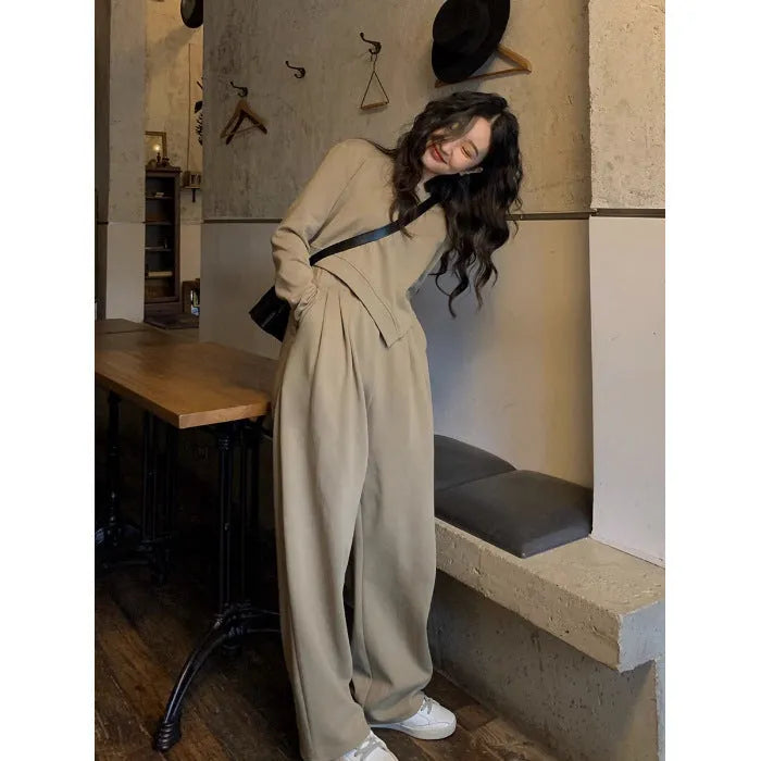 Women's khaki coloured loose-fit casual sports suit with long sleeves and trousers on a hanger.