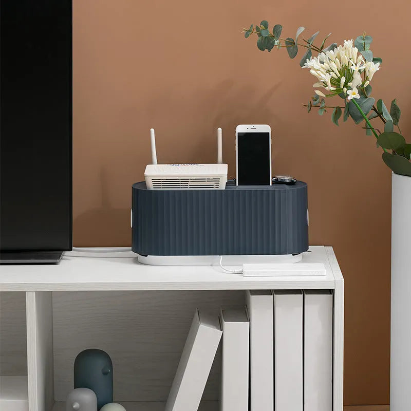 Blue and white desktop power strip storage organiser box with cable holes and a detachable cover.