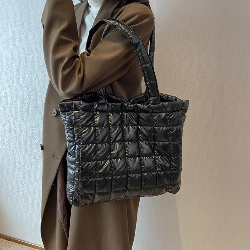 Large nylon plaid bucket shoulder bag in black with rhombus pattern, magnetic buckle, and soft handle.