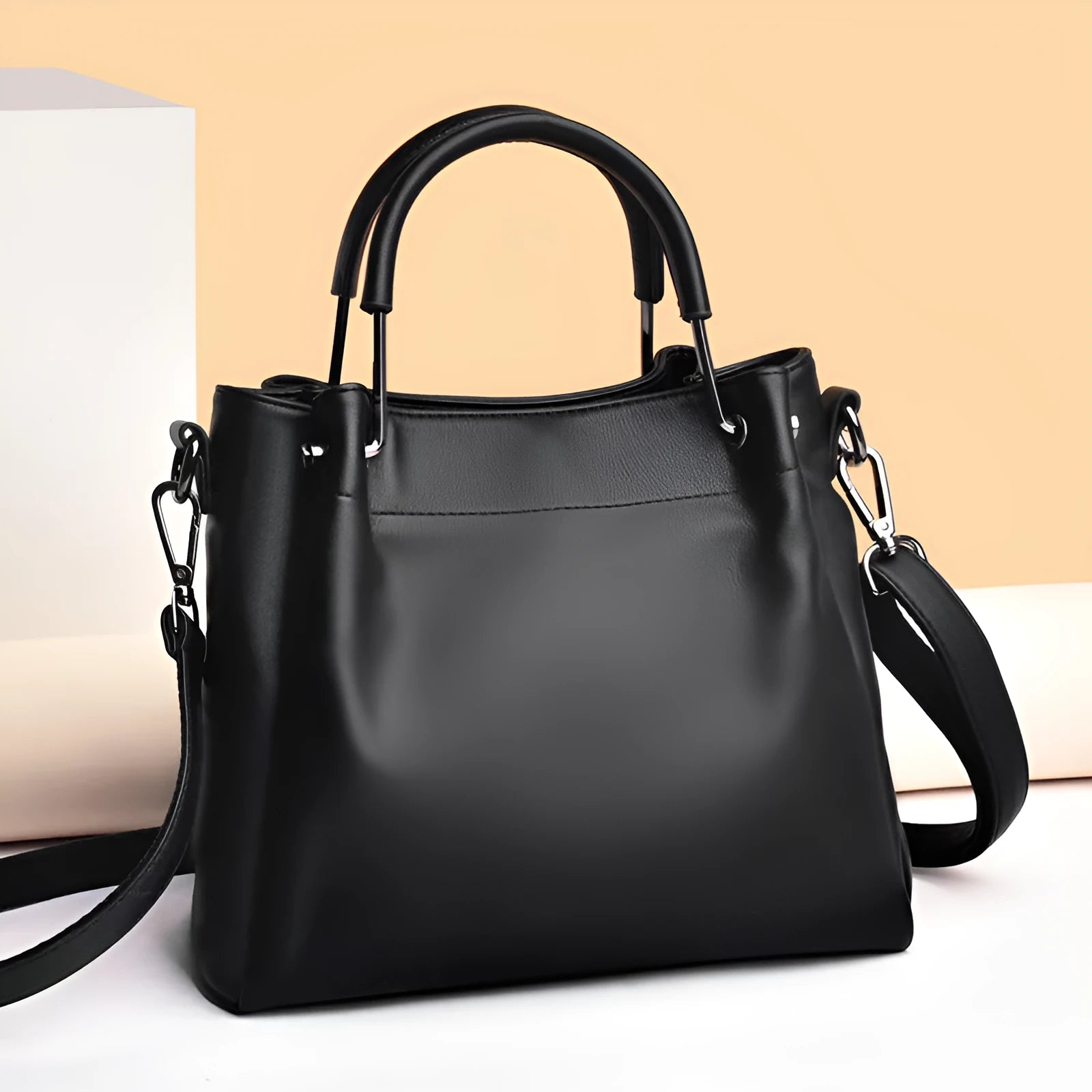 Soft PU leather bucket bag in black with visible sewing thread and external slit pocket