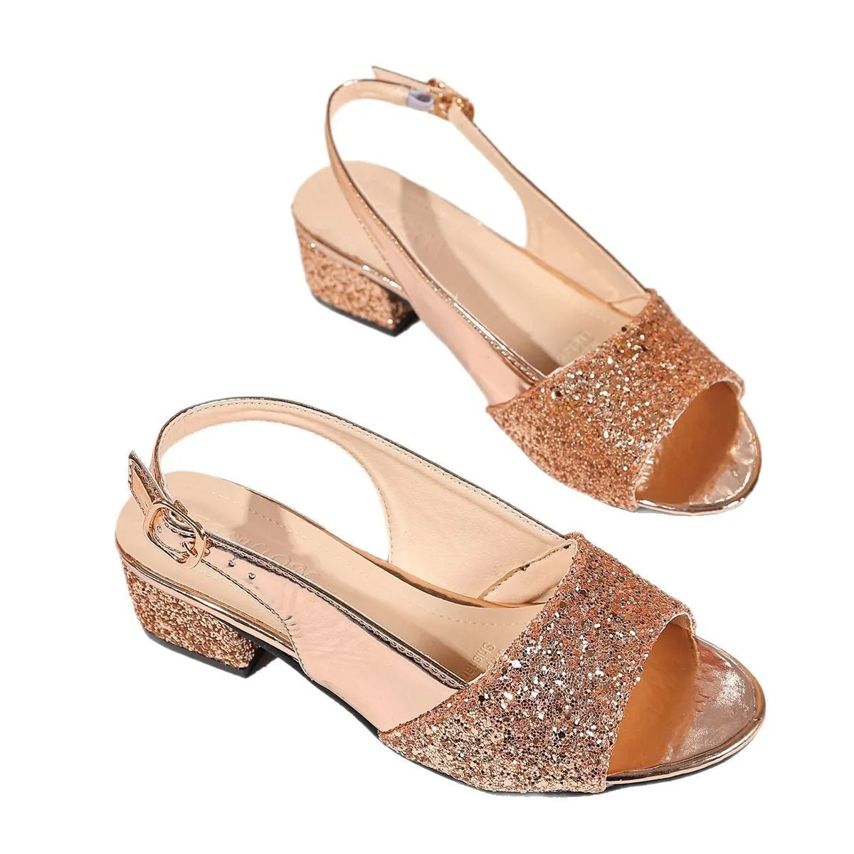 Gold open toe fish mouth sandals with an adjustable buckle on a wooden floor.
