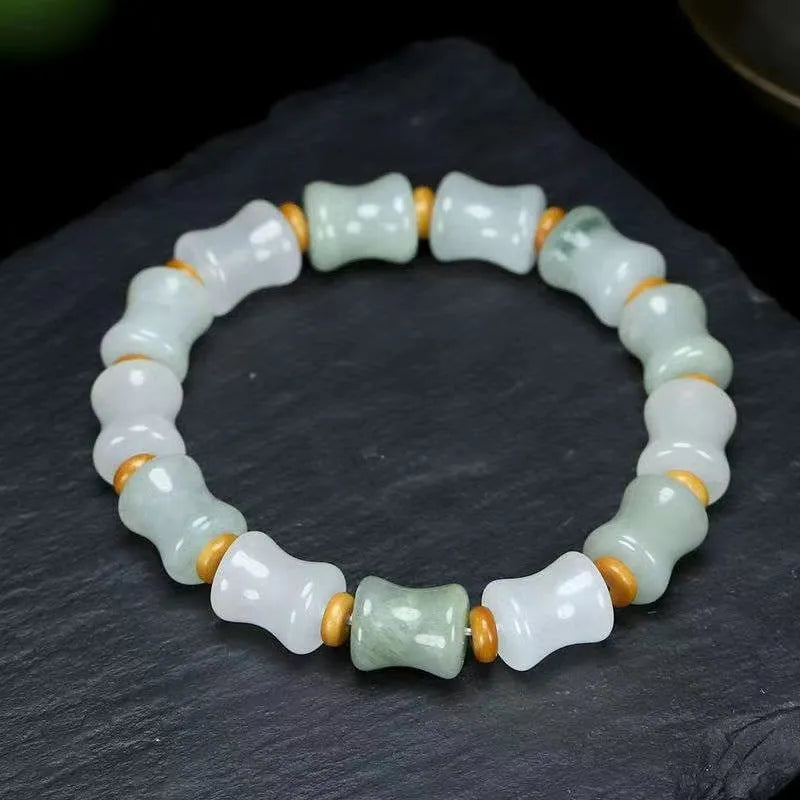 Simple beaded bracelet with chalcedony and coconut shell beads, diamond jade piece, and safety lock.