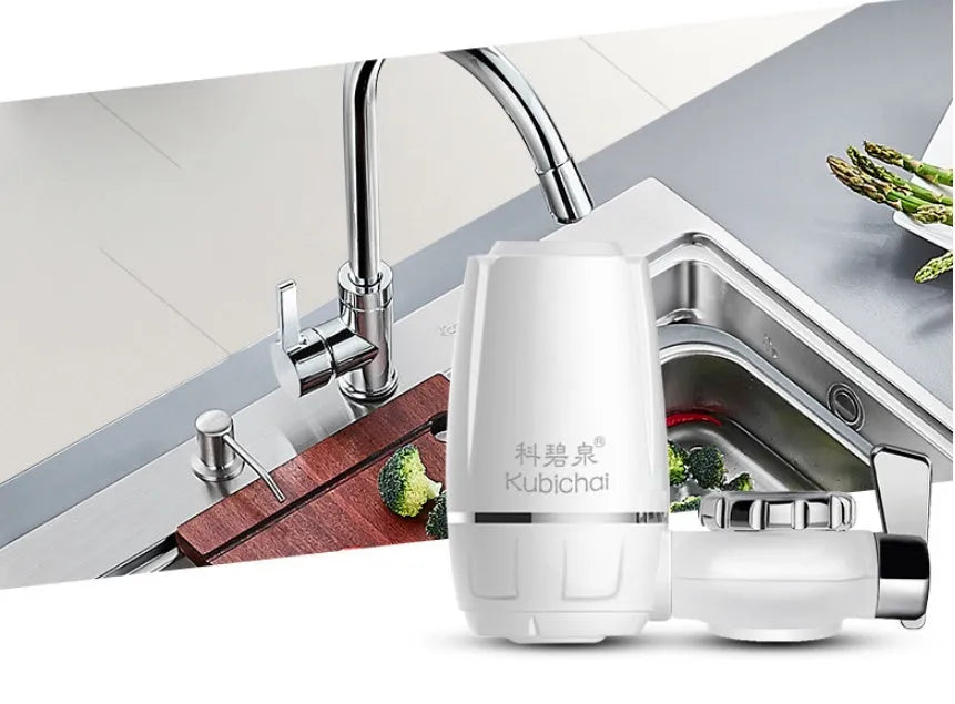White plastic faucet water purifier with ceramic filter cartridge mounted on kitchen tap