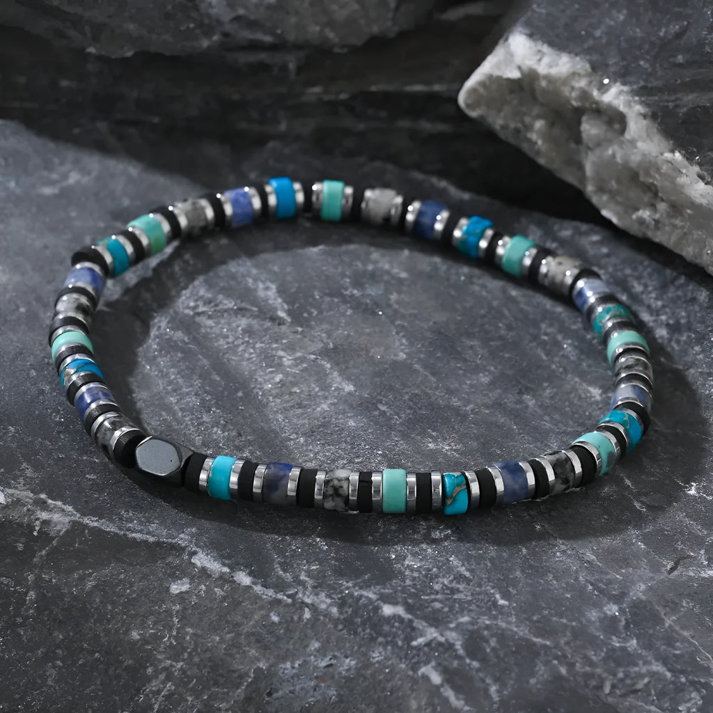 Hand-woven cylindrical bracelet with geometric pattern of natural semi-precious stones.