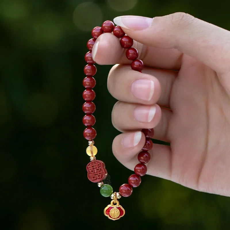 Emperor sandstone cinnabar bracelet with fu charm in 6mm and 8mm bead sizes.