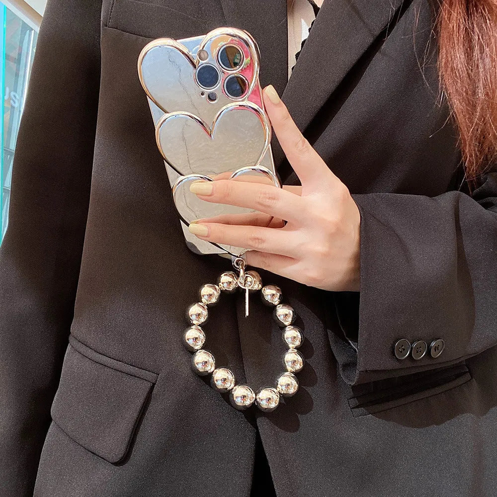Soft TPU iPhone case with a silver electroplated love design on the back, shown next to a matching bracelet.