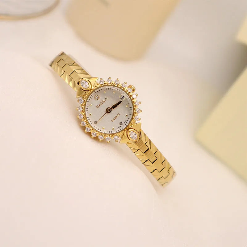 Vintage quartz bracelet watch with diamond-embossed detailing and golden face