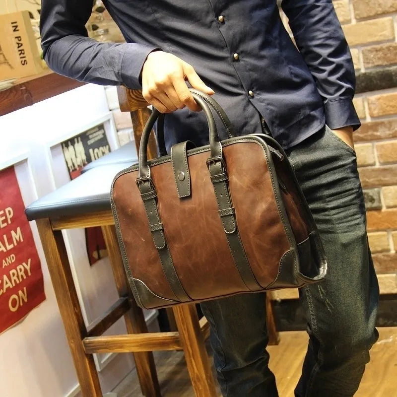 Men's cowhide leather brown business messenger bag with zip closure and shoulder strap on a wooden table