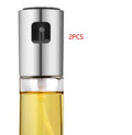 Gold ABS and glass oil and vinegar spray bottle with push-type pump, 17.5cm tall.