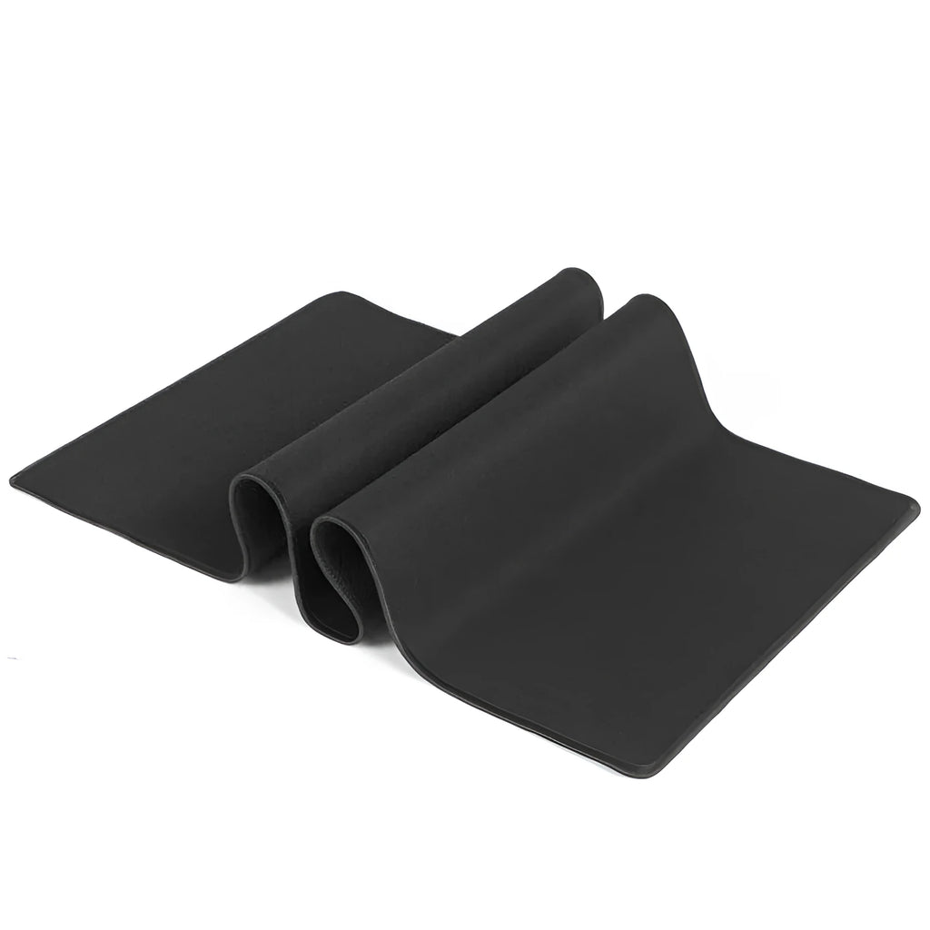 All black extended large desk mat with overlock stitching for keyboard and mouse on a wooden desk.