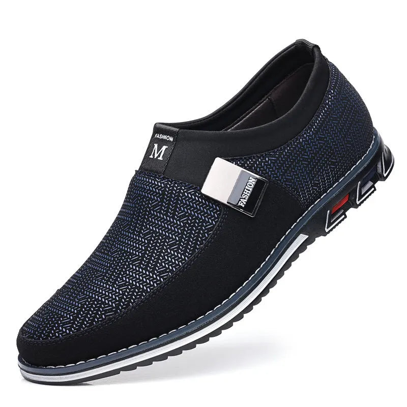 Men's synthetic leather slip-on casual shoe in black, showing square toe and flat rubber sole.