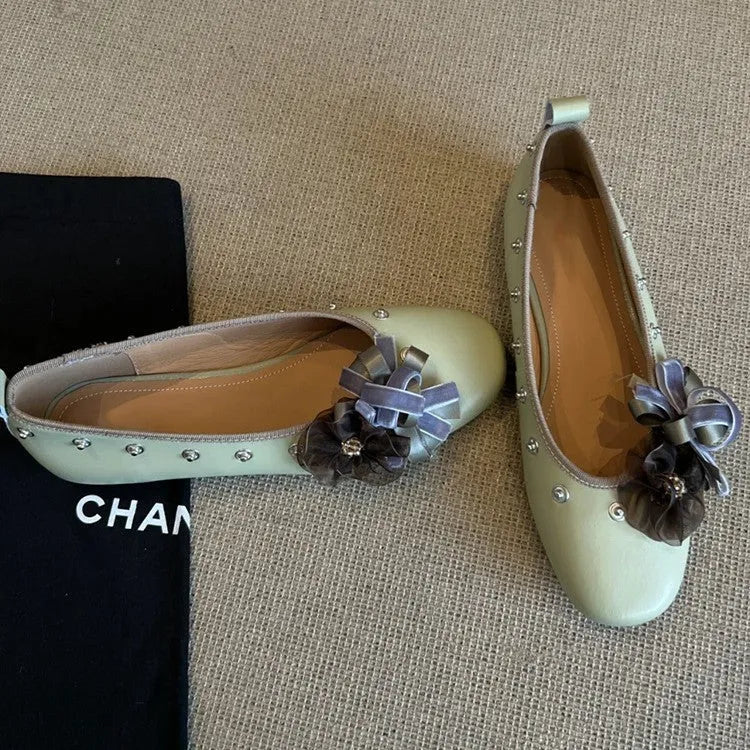 Women's silver Mary Jane flat shoes with a buckle strap and sheepskin upper.