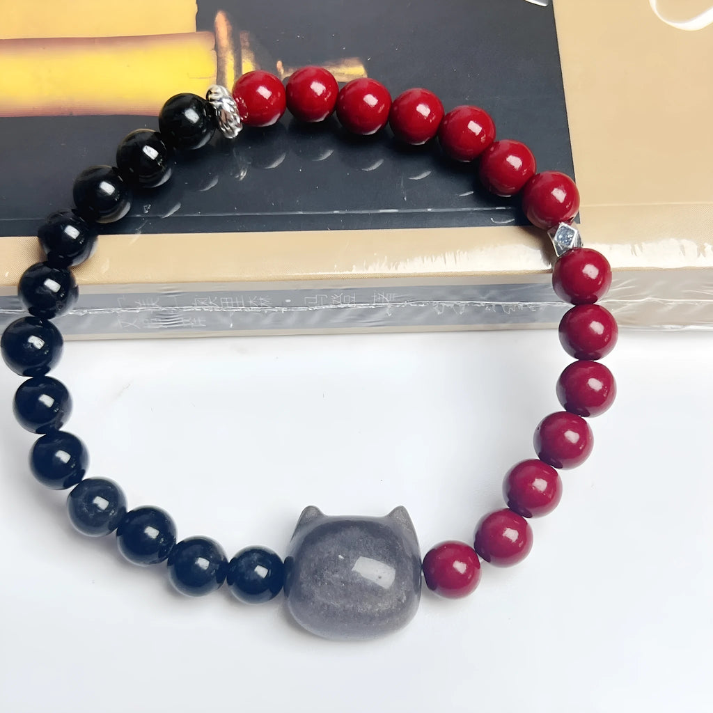 Handmade obsidian gemstone bracelet with cat charm on black elastic cord