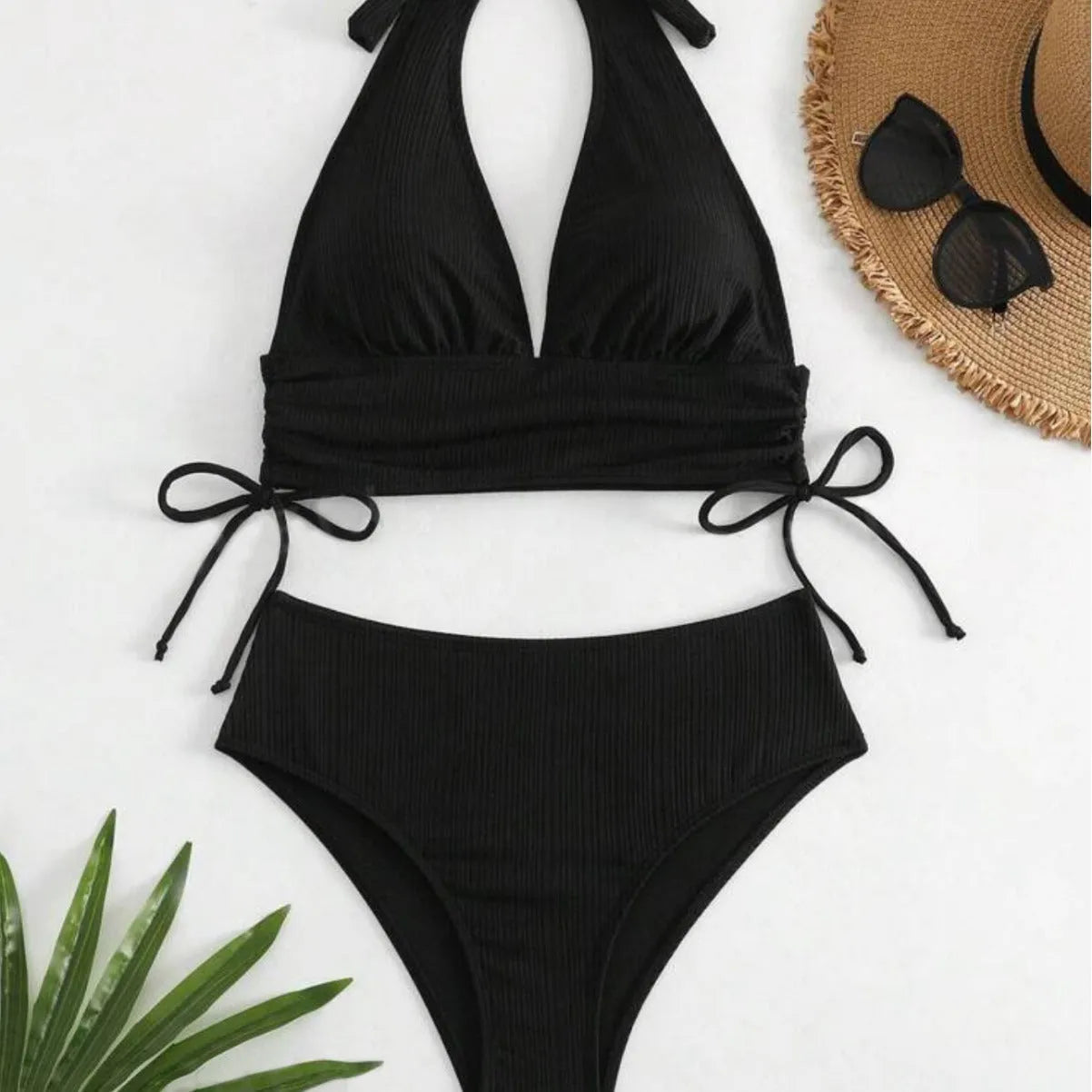 Black lace-up halter bikini set with matching briefs on mannequin