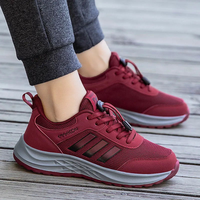 Unisex elastic band slip-on trainer with breathable mesh upper in black, dark grey, purple or purplish red.