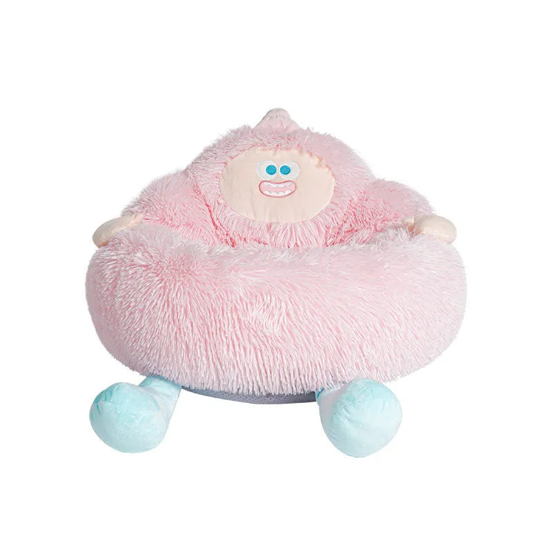Grey plush round pet nest bed with raised rim for cats and dogs, shown in a home setting.