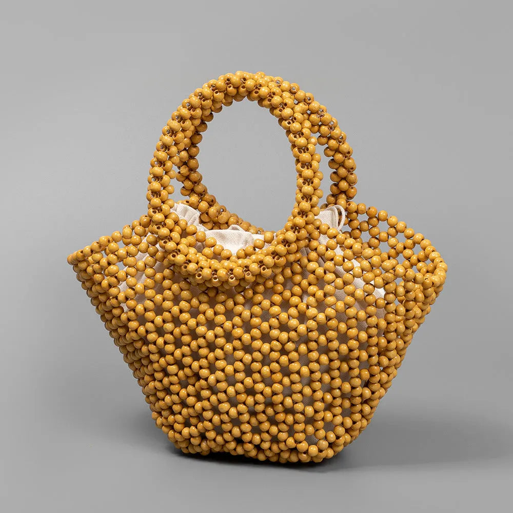 Hand-woven maple beach bag with wooden bead decoration showing hollow dumpling design