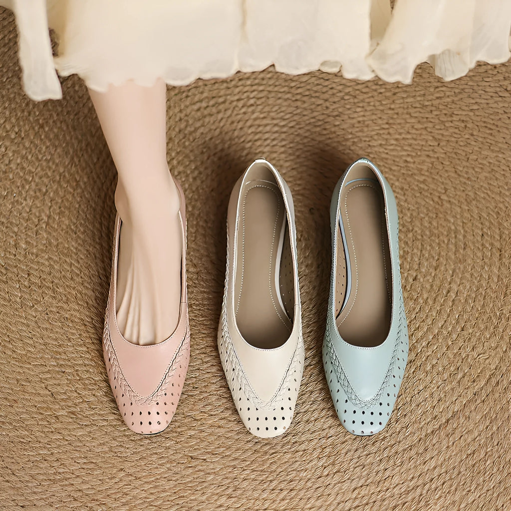 Women's beige mid-heel sandals with hollow-out design and round toe on a light background.