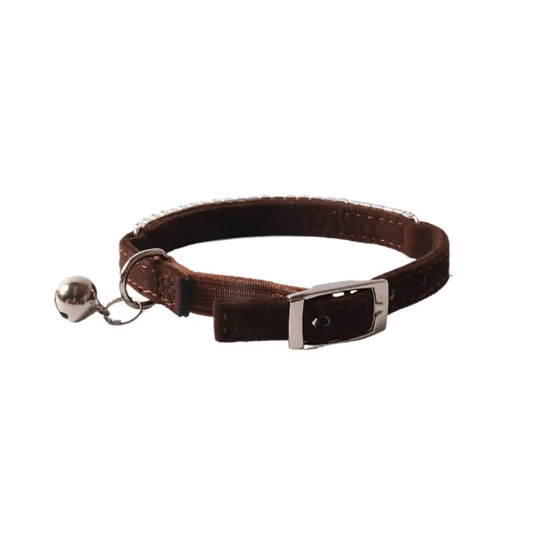 Pink flannel cat collar with elastic buckle and gang drill pattern lying flat.