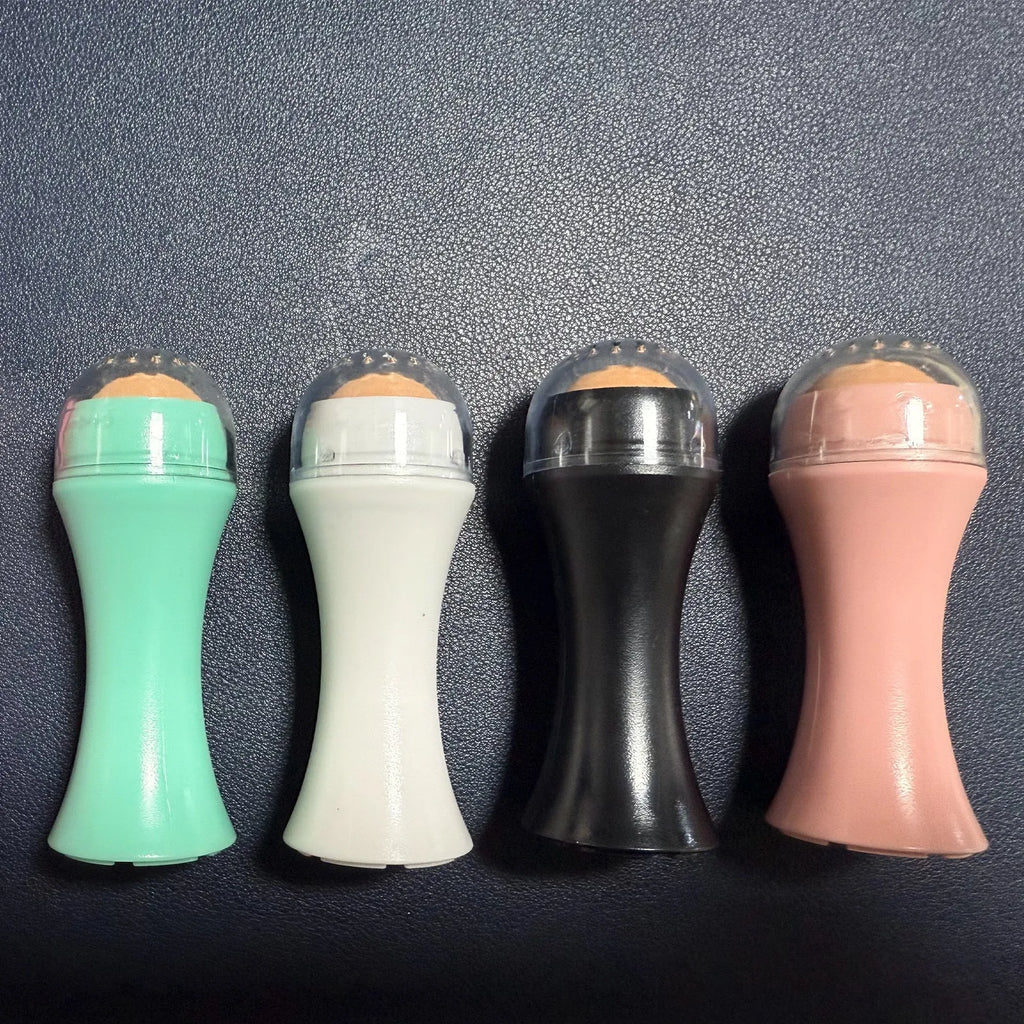 Volcanic stone portable roller for oily skin control in black, green, pink, and white.