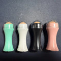 Volcanic stone portable roller for oily skin control in black, green, pink, and white.