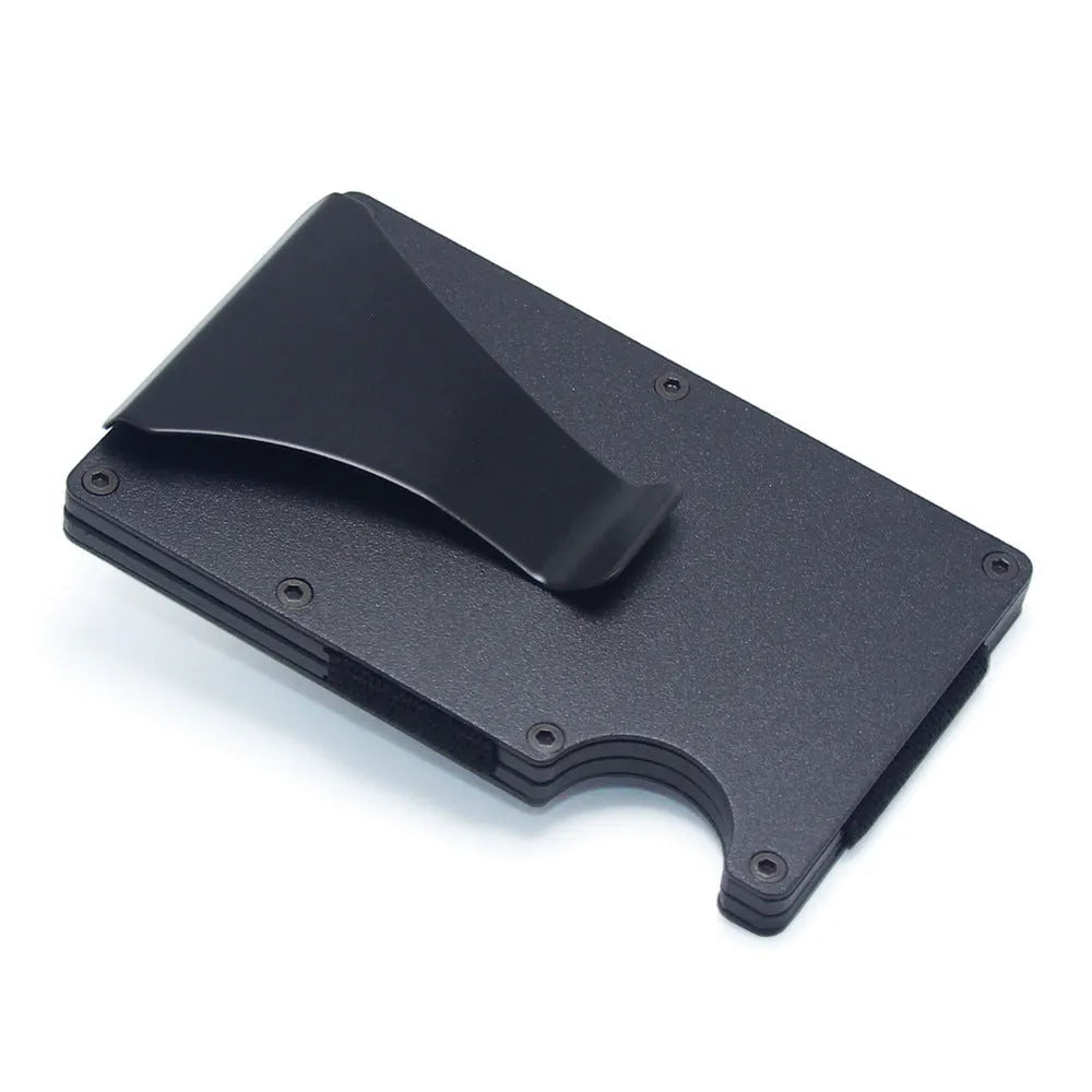 Slim black carbon fibre card holder wallet with geometric design on a desk.