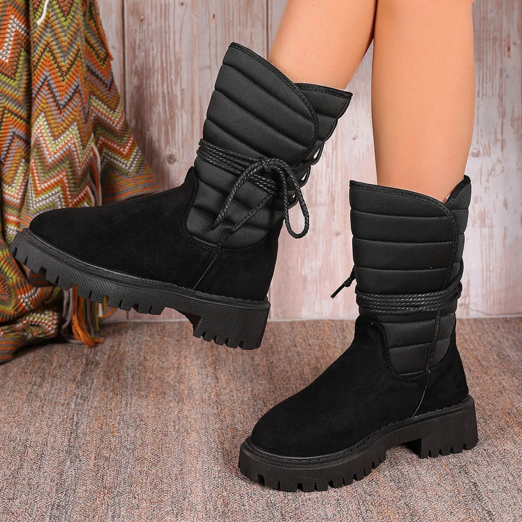 Women's black suede high-top winter boots with a chunky heel and lace-up front, fleece-lined.