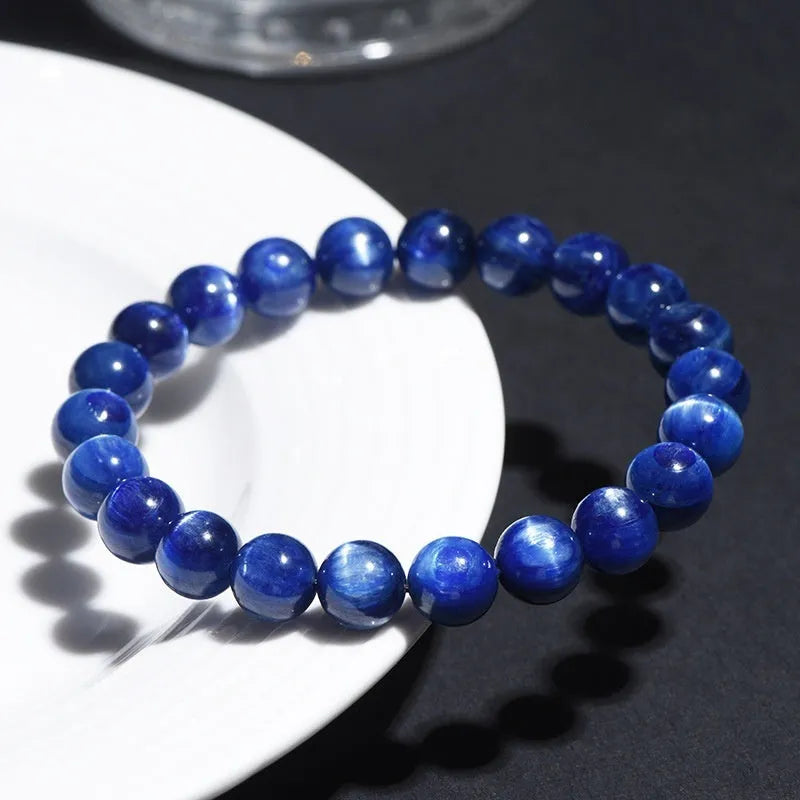 Natural blue crystal ball bracelet with geometric Ruyi design on a wrist.