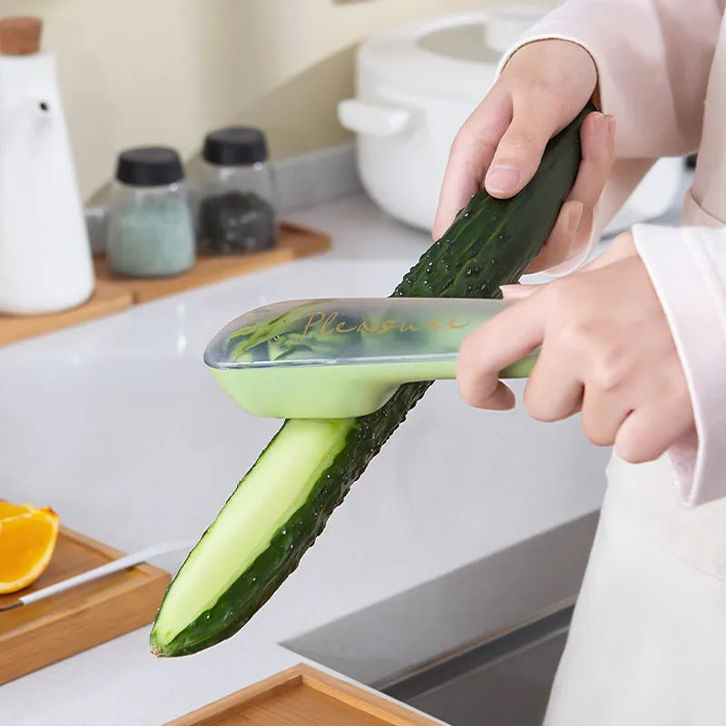 Green plastic handled vegetable peeler stored inside its own clear plastic tube.