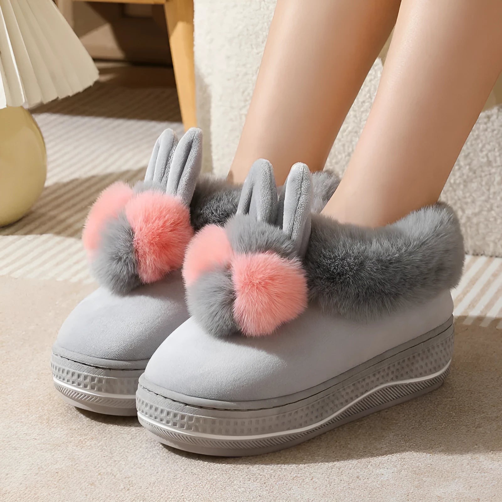 A pair of thick-soled high heel slippers in plush material with a TPR sole, shown in grey colour.