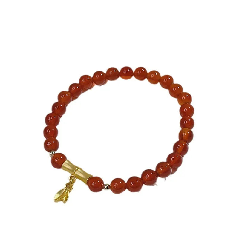 Close-up of a handmade red agate bracelet for women with a traditional Chinese dragon design.
