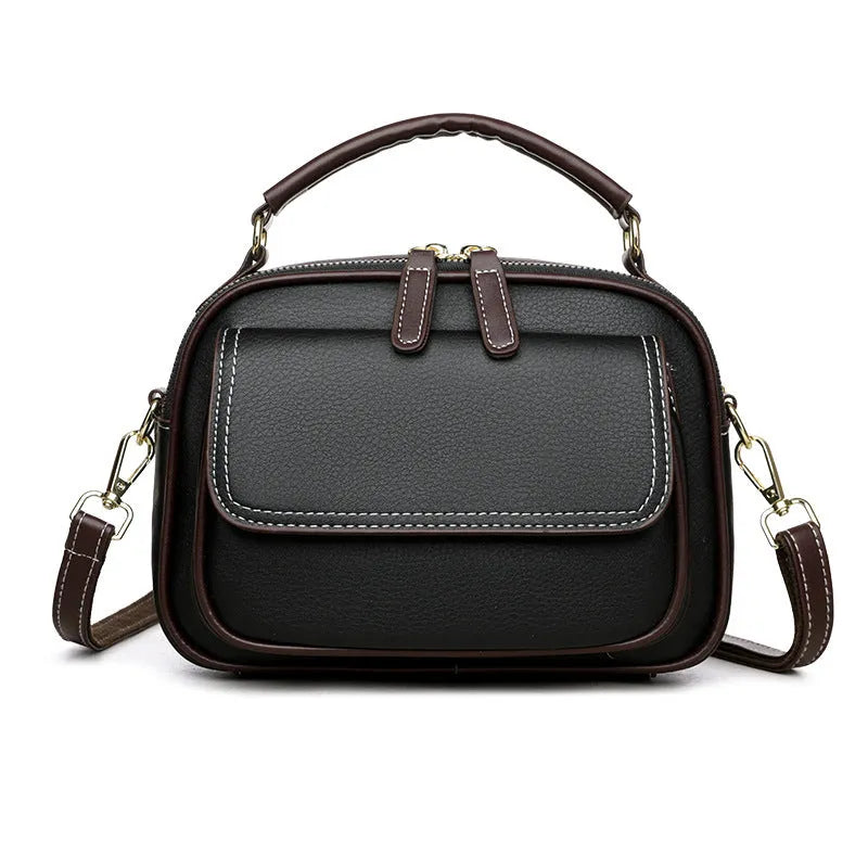Women's black PU leather cross-body shoulder bag showing horizontal square shape and double straps