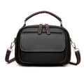 Women's black PU leather cross-body shoulder bag showing horizontal square shape and double straps