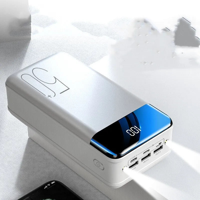 Black and white 50000mAh power bank showing three USB output ports and compact design