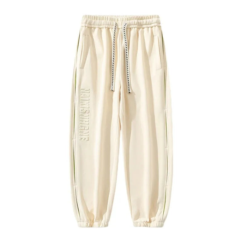 Men's grey green loose-fit cargo trousers with visible stitching detail and a banded ankle opening.